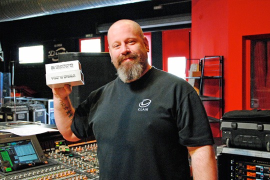 Cam Beachley stands at the mixing console with the Type 10 and Type 10S DI boxes.
